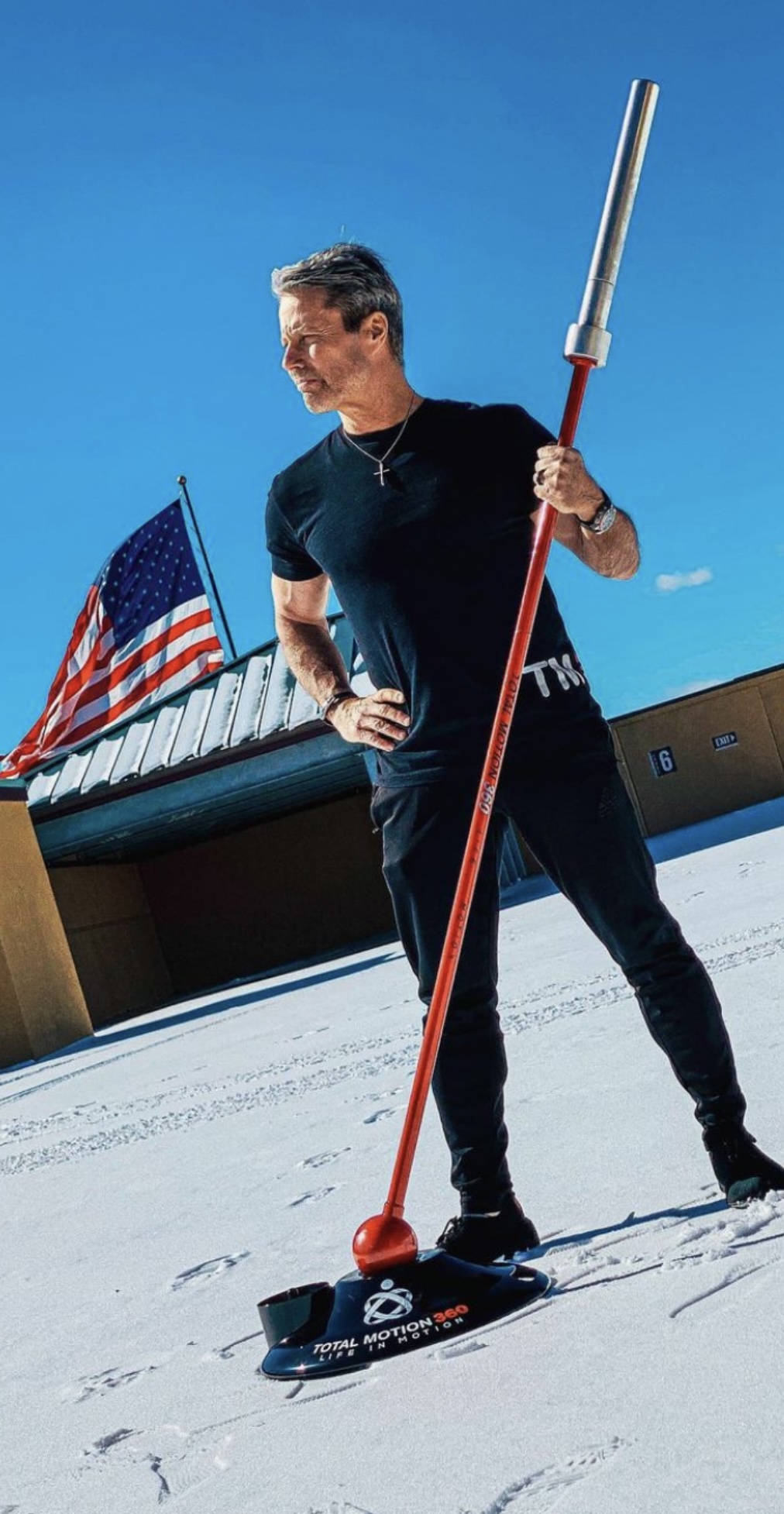 Tom Fabbri holding the patented TM360 Power Bar with the American flag